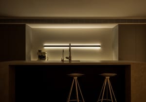 A modern kitchen with a concrete countertop and minimalist design.