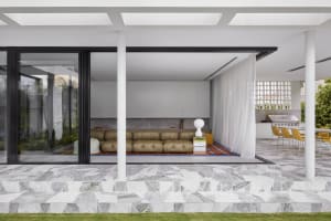 Modern minimalist living room with concrete, leather, and marble elements