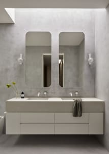 Modern minimalist bathroom with concrete walls, white floor, and a double vanity with a white countertop.