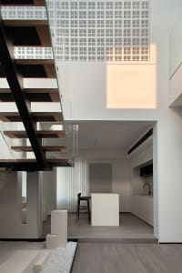 Modern minimalist interior design with open-plan layout, featuring sleek, contemporary materials and clean lines.