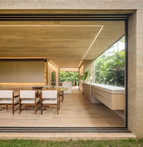 Modern dining room with concrete ceiling and wooden floor and chairs