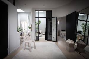 A minimalist residential interior with mixed materials and a modern, open-concept layout.