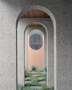 A modern architectural entrance with a textured concrete wall featuring a circular window and an arched doorway.
