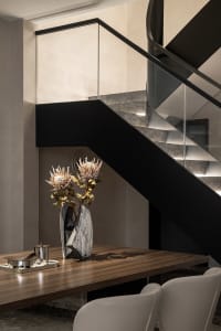 Modern staircase featuring a combination of stone and wood materials.
