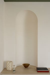 Modern shelf featuring ceramic vases and bowls.