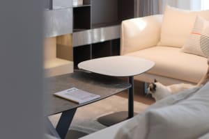 A modern living room featuring a marble coffee table and a suede sofa.