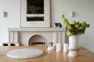 A minimalist room featuring stone elements and greenery.