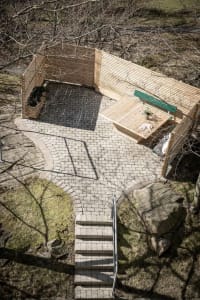An architectural exterior designed with brick pavers and timber elements.