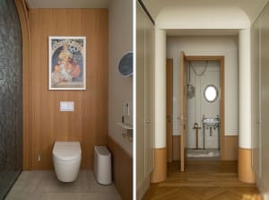 Modern bathroom interior with wooden walls, a vintage poster, and sleek fixtures.