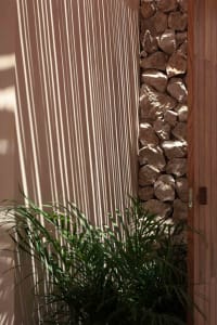 Modern indoor design featuring a wall adorned with natural stone decorations.