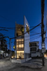 Modern interior design featuring glass elevations at night with illuminated windows.