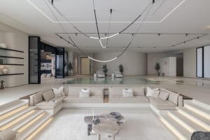 Interior design featuring modern minimalist living space with exposed concrete floors, wooden accents, and large glass walls.