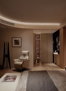 A minimalist bedroom featuring a wooden floor and furniture.
