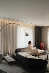 A modern living room featuring textured leather and cotton-blend materials, with a minimalist interior design.