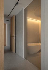 An elegant modern bathroom featuring concrete walls and minimalist design.