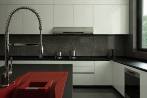 Modern kitchen featuring sleek metal appliances and marble countertops.