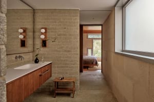 Modern bathroom featuring concrete walls and minimalist design