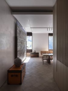Modern interior design featuring concrete, stone, and wood elements.