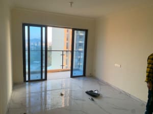 Empty apartment with marble floors, glass balcony doors, and metal frame