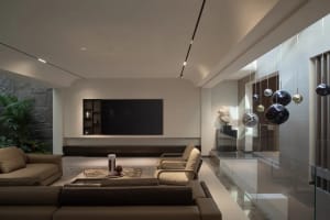 Contemporary living room featuring modern furniture with minimalist design, leather sofas, stone accents, and metal decor.