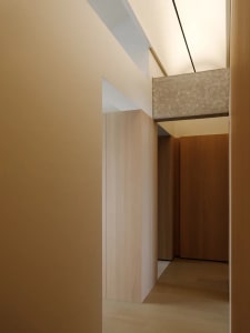 A minimalist closet with wooden paneling and clean lines.
