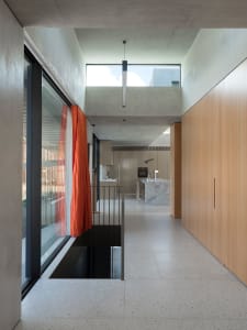 A modern interior space featuring concrete and glass materials.