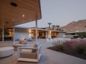 Modern minimalist patio featuring concrete, wood, and glass materials