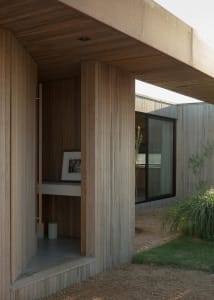 A wooden doorway leading into a designed architectural space.