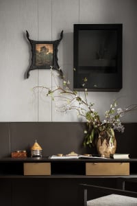 A modern desk space featuring a combination of materials including leather, wood, and metal.