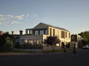 Modern residential house exterior with concrete and brick materials.