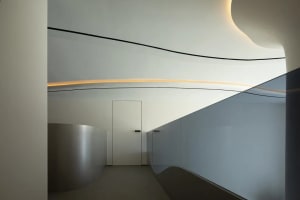 Smooth, curved surfaces made of glass and metal in a minimalist design