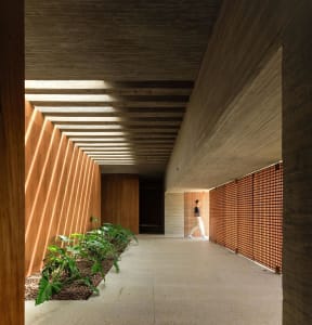 A modern corridor with wooden walls and concrete floor