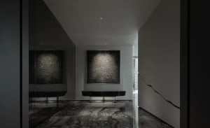 Interior design of a modern minimalist lobby featuring concrete finishes and space.