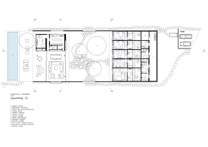 A detailed architectural plan of the ground floor of a building, showing rooms and outdoor spaces.