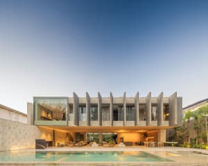 A modern residential building with concrete and glass features.