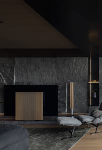 Modern interior design featuring a sleek concrete fireplace and contemporary furniture in a living room.