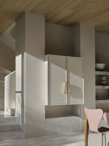 A modern interior design featuring clean lines and white cabinets.