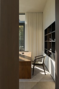 A modern living room featuring wooden furniture and glass elements.