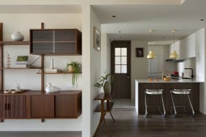 A modern kitchen with minimalist design and wooden features.