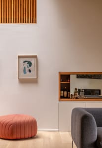 Modern minimalist living space featuring wood elements