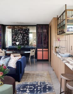 A modern interior design featuring a mix of materials such as wood, marble, and metal.