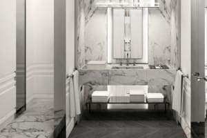 A modern bathroom interior featuring marble countertops and flooring.