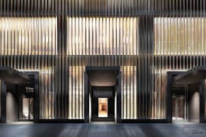 A modern lobby featuring metal walls and windows.