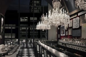 A luxurious restaurant bar with glass chandeliers and contemporary design elements.