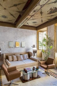 A modern residential living room featuring concrete walls and wood accents.