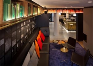 A modern, minimalist interior with a black metal reception desk, designed for a contemporary office space.