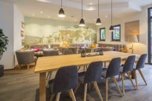 A cozy café interior with wooden furniture and comfortable seating areas.