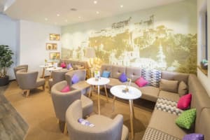 A cozy, modern cafe with comfortable seating and decorative accents.