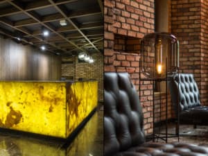 Industrial-style lobby featuring brick walls and wooden ceiling.