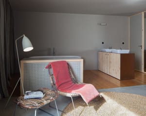 Modern bathroom interior design featuring wooden and concrete elements.